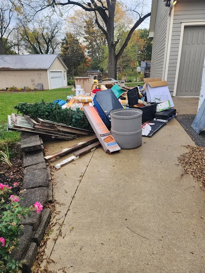 Dumpster being loaded with debris for Roofing Dumpster Rental in Wilson's Mills